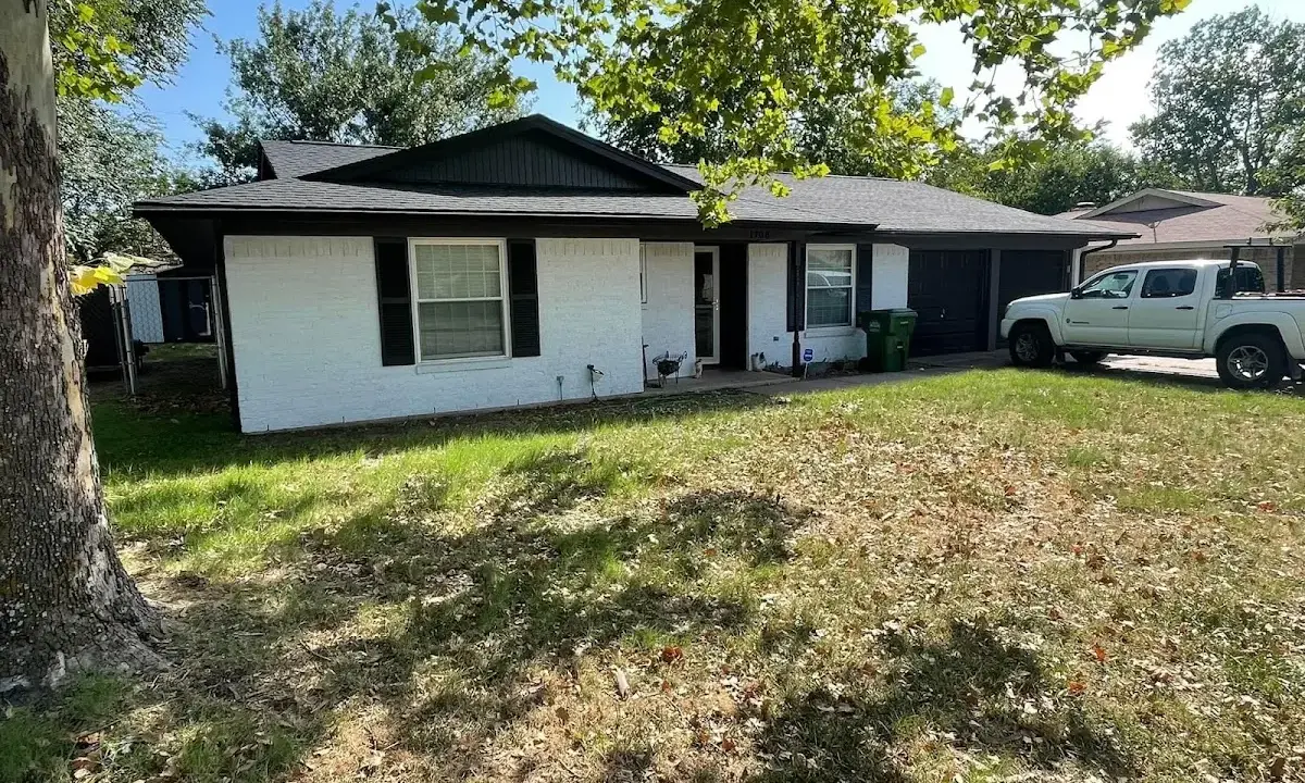 Professional roofing crew working on a residential roof in Sheridan